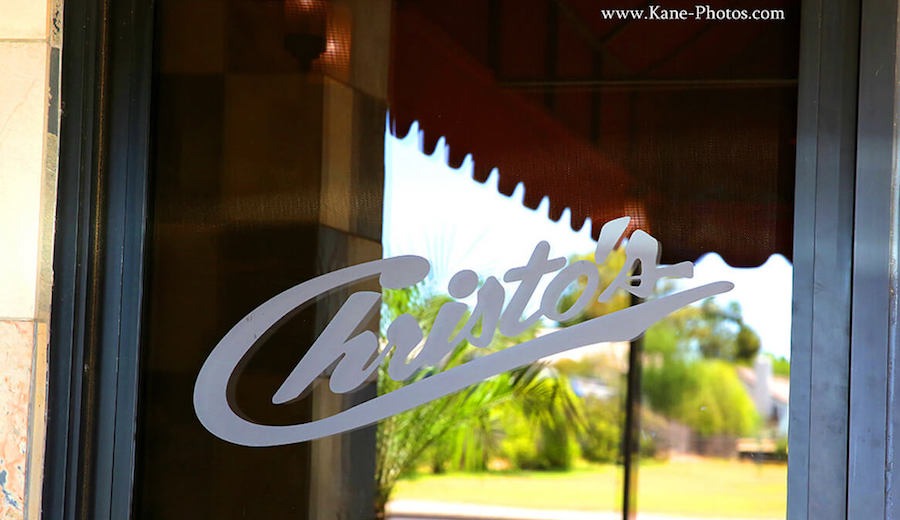Restaurant sign on a stone wall
